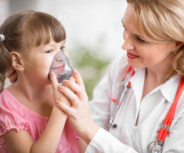 48782287-pediatrician-doctor-making-inhalation-to-kid